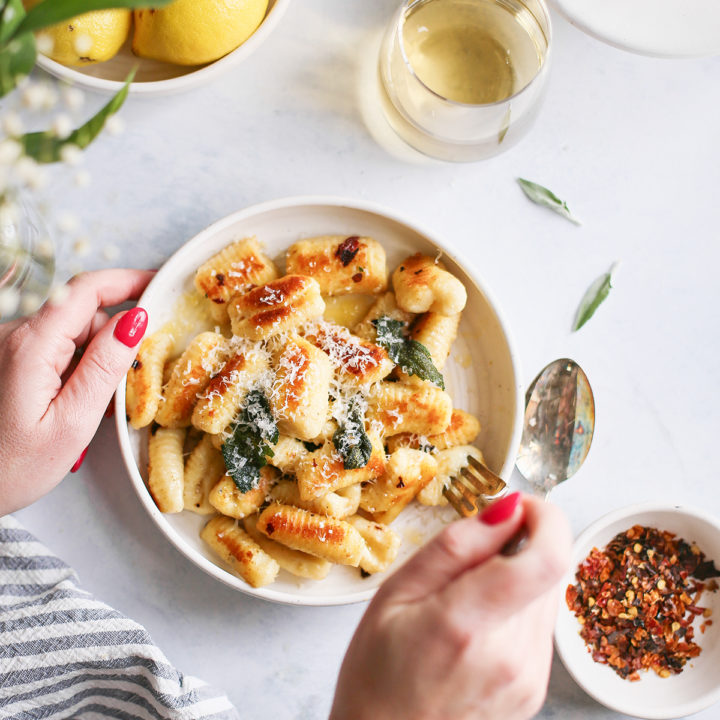 woman eating brown butter and sage gnocchi