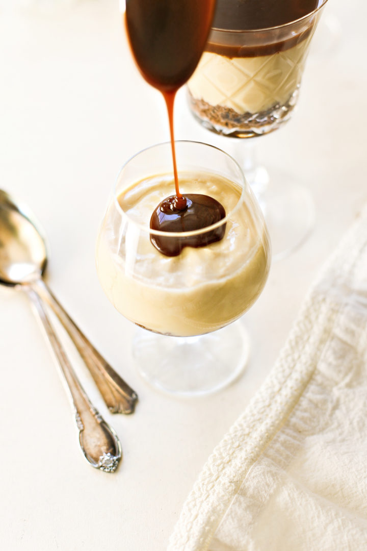 salted caramel being poured on top of a budino dessert