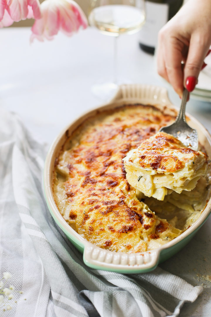 woman serving scalloped potatoes