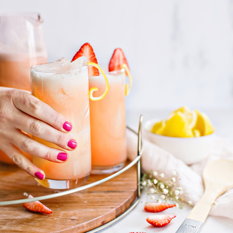 woman holding a glass of strawberry lemonade