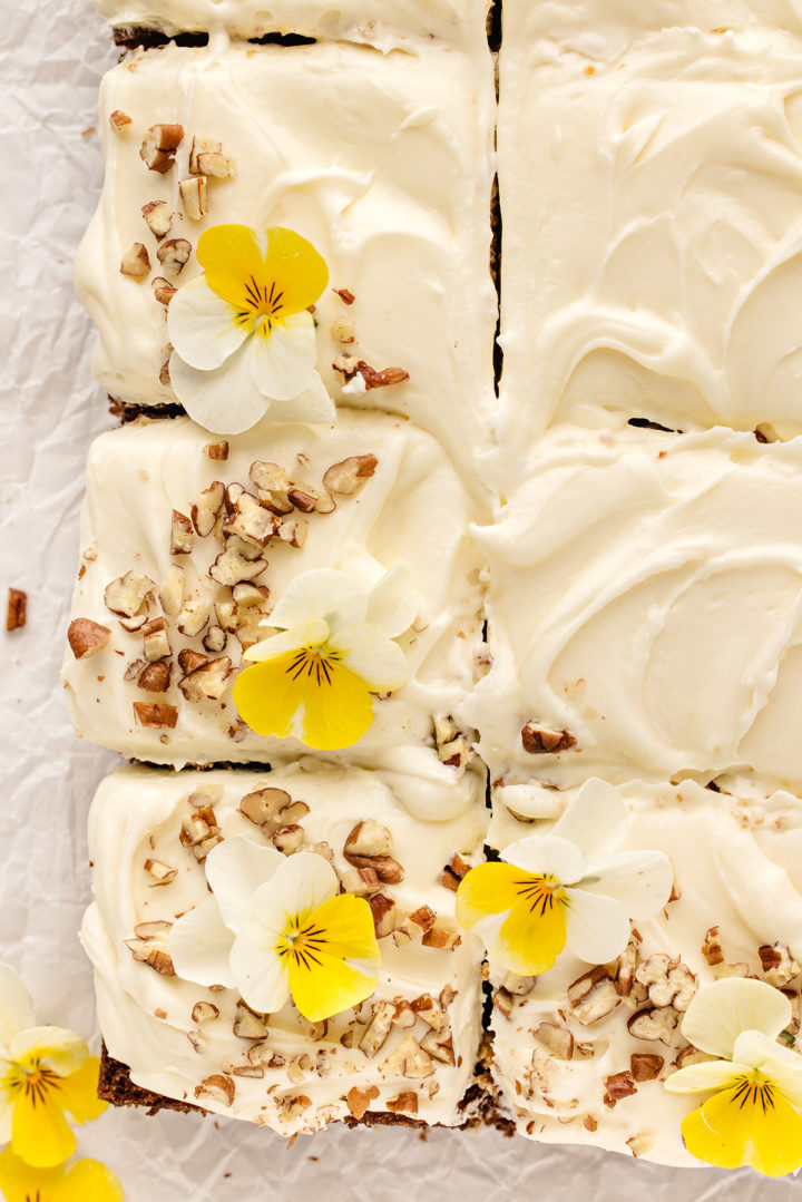 overhead photo of a moist carrot cake with pineapple cut into squares