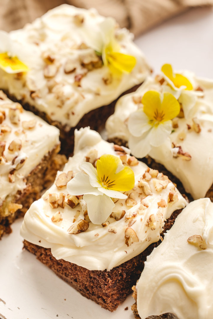 squares of carrot cake with crushed pineapple decorated with nuts