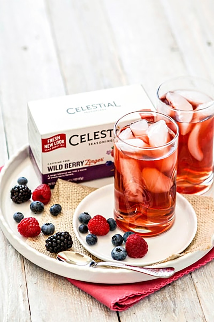 celestial seasonings ice tea in a glass with berries and tea box