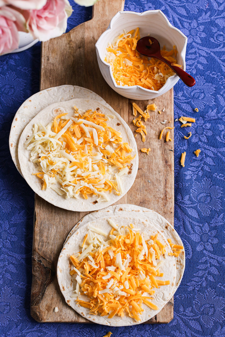 tortillas and cheese assembling breakfast quesadillas