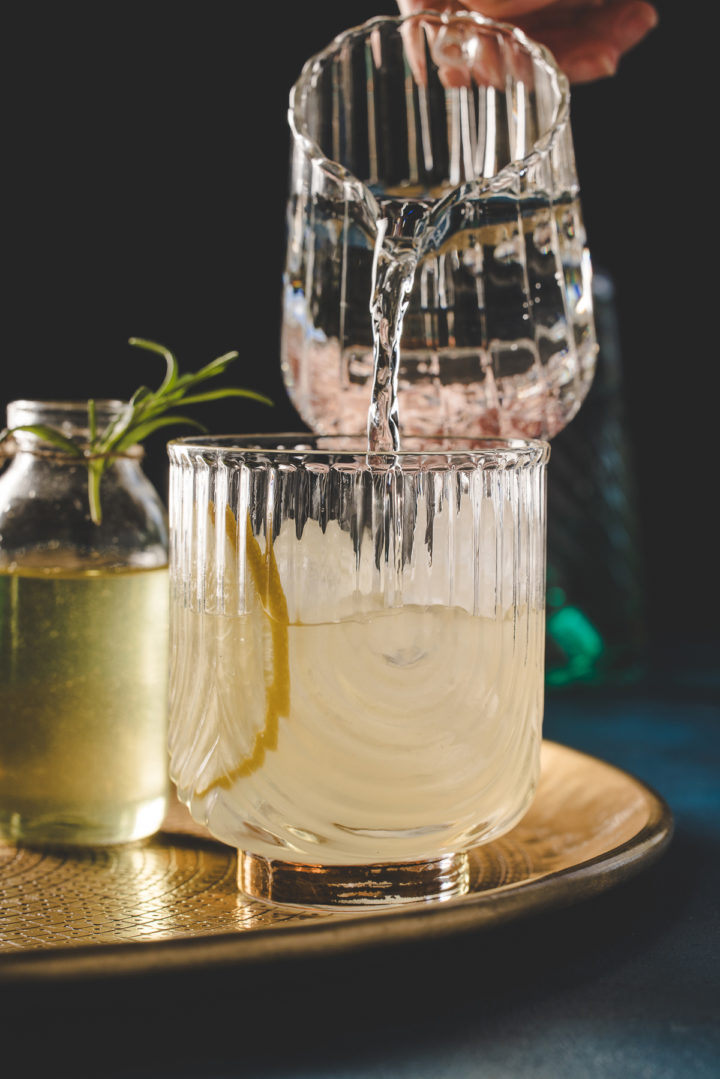 step 5 for making a gin fizz cocktail: top glass off with club soda