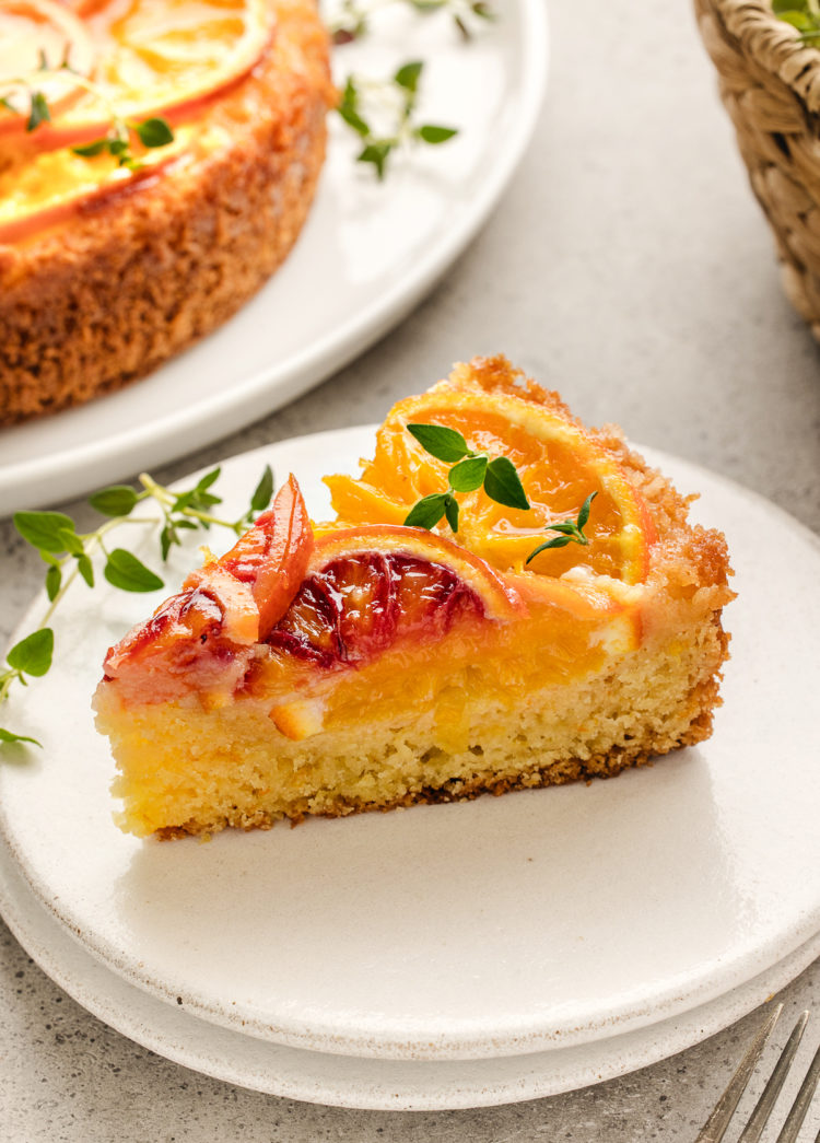 slice of upside-down orange cake on a white plate