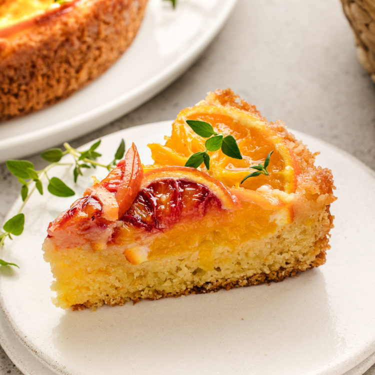 slice of upside-down orange cake on a white plate