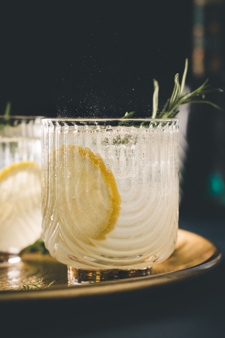 gin fizz in a glass with fresh rosemary