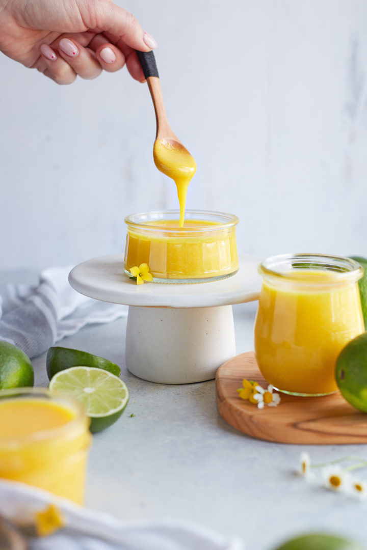 woman serving a spoonful of lime curd