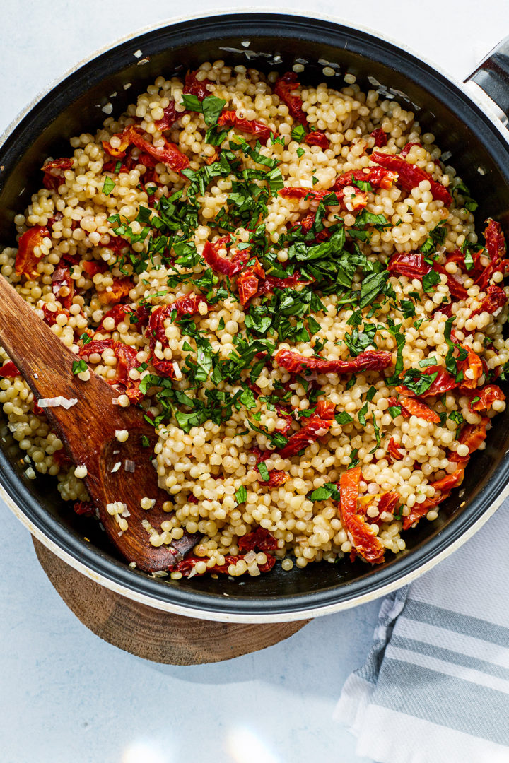 how to make pearl couscous salad: step 4 - stir in the herbs