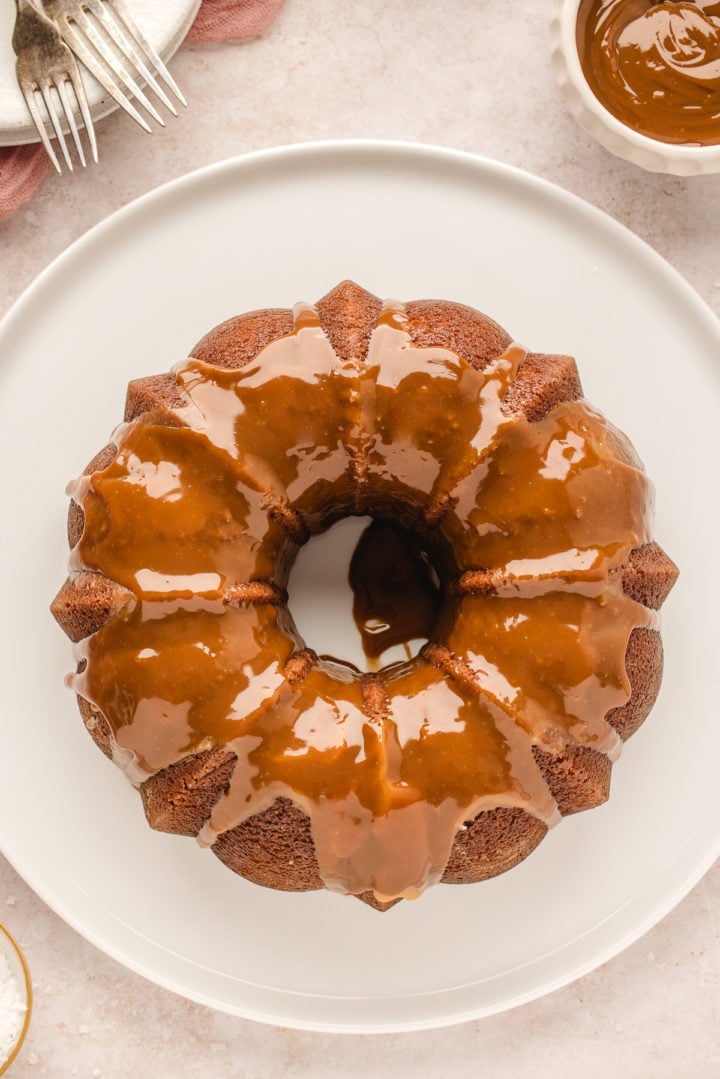 overhead photo of a salted caramel kentucky butter cake on a white serving platter