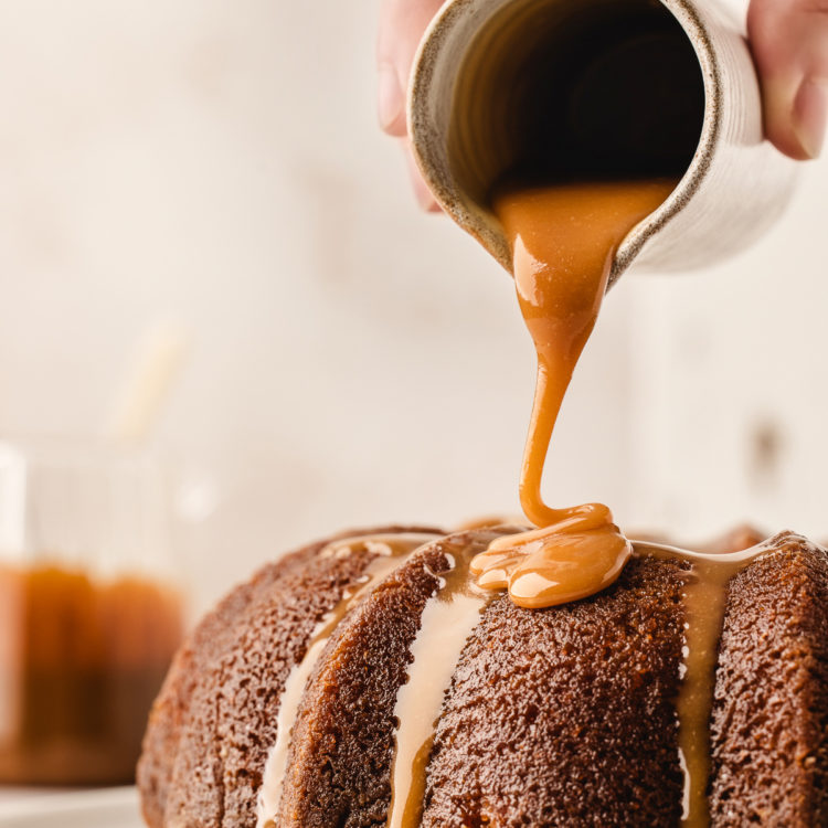 pouring salted caramel sauce on top of a kentucky butter cake