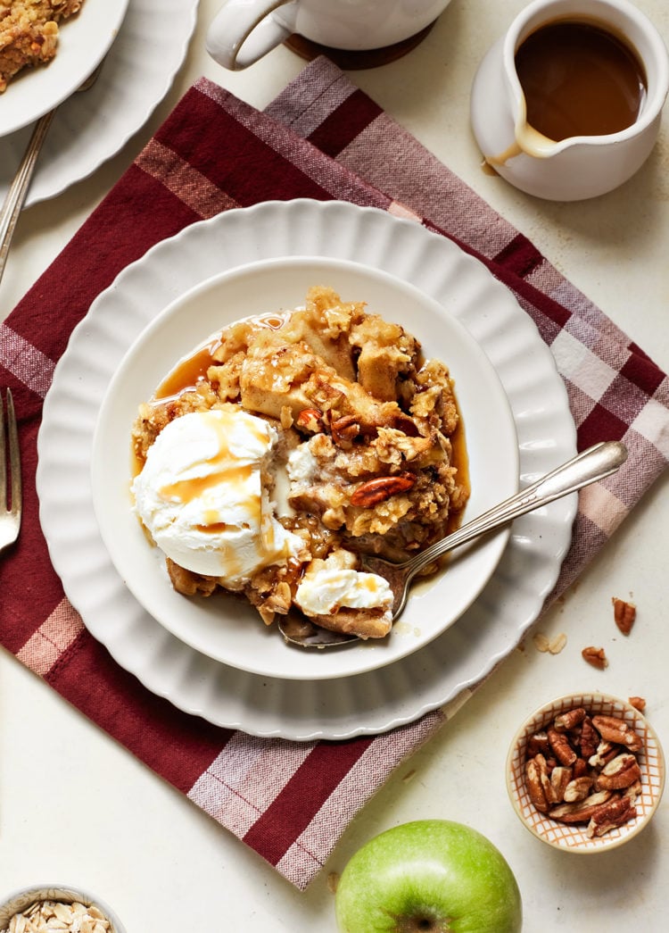overhead view of caramel apple crisp on a plate with ice cream