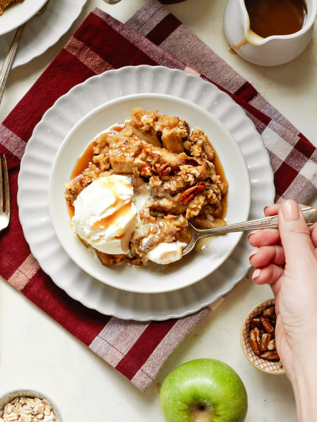 woman eating a bowl of caramel apple crisp with ice cream