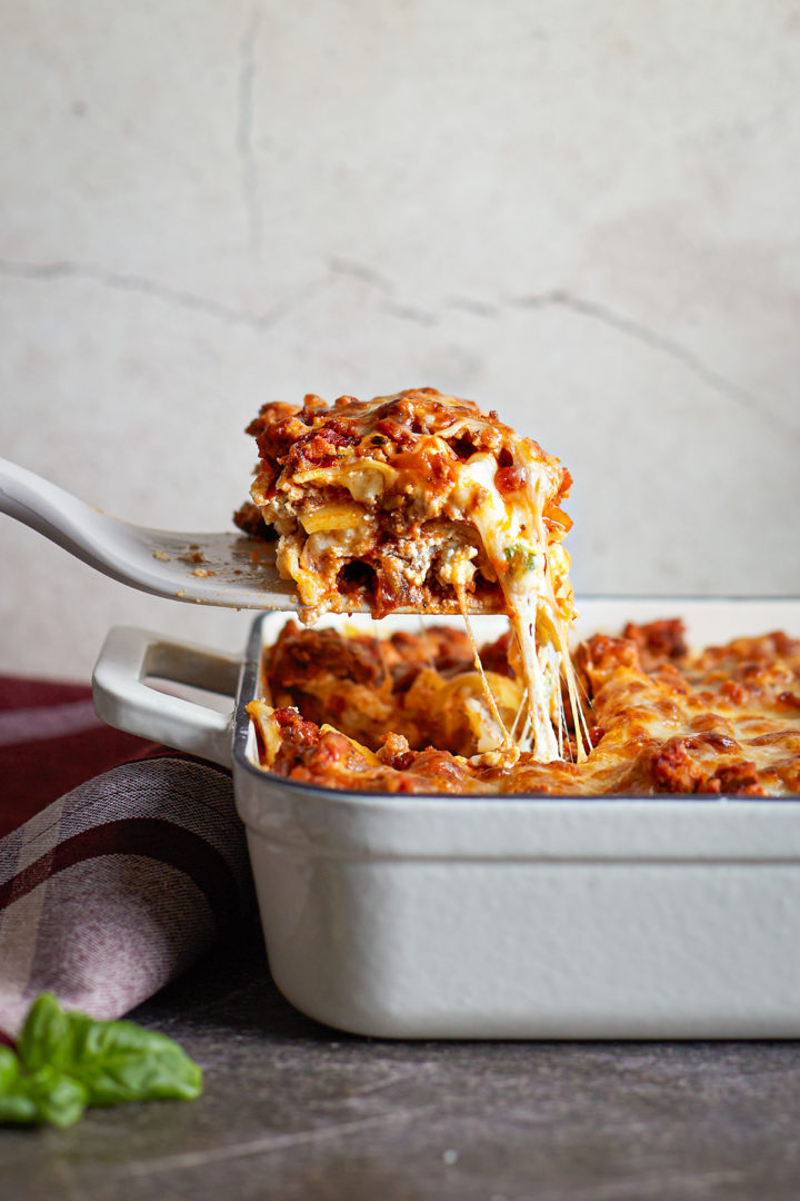 Slice of lasagna being pulled from pan