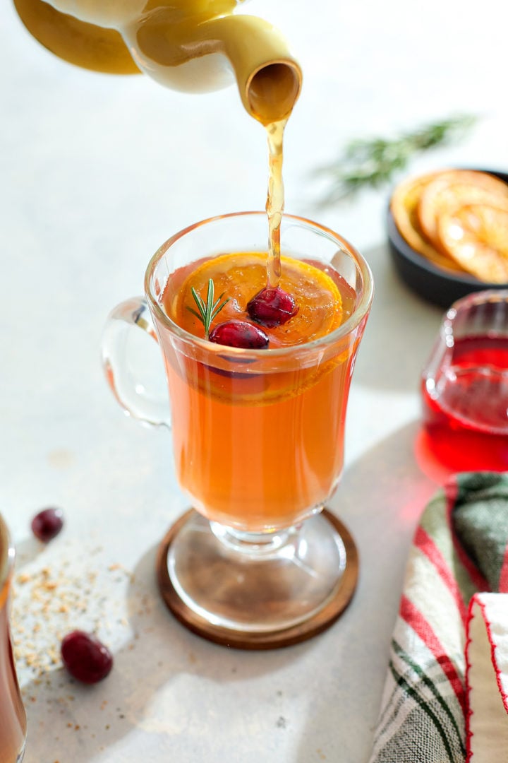 Pouring herbal tea into a hot toddy.