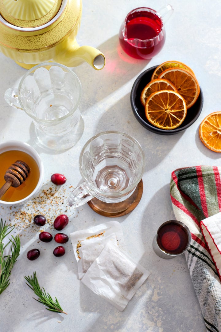 Ingredients needed to make a cranberry whiskey hot toddy with ginger tea.