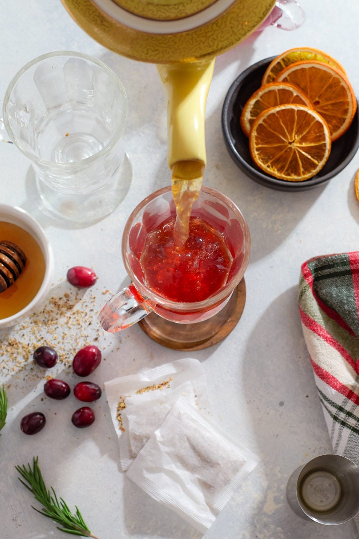 Pouring herbal tea into a hot toddy.