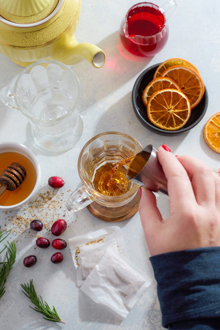 Building a hot toddy in a glass mug.